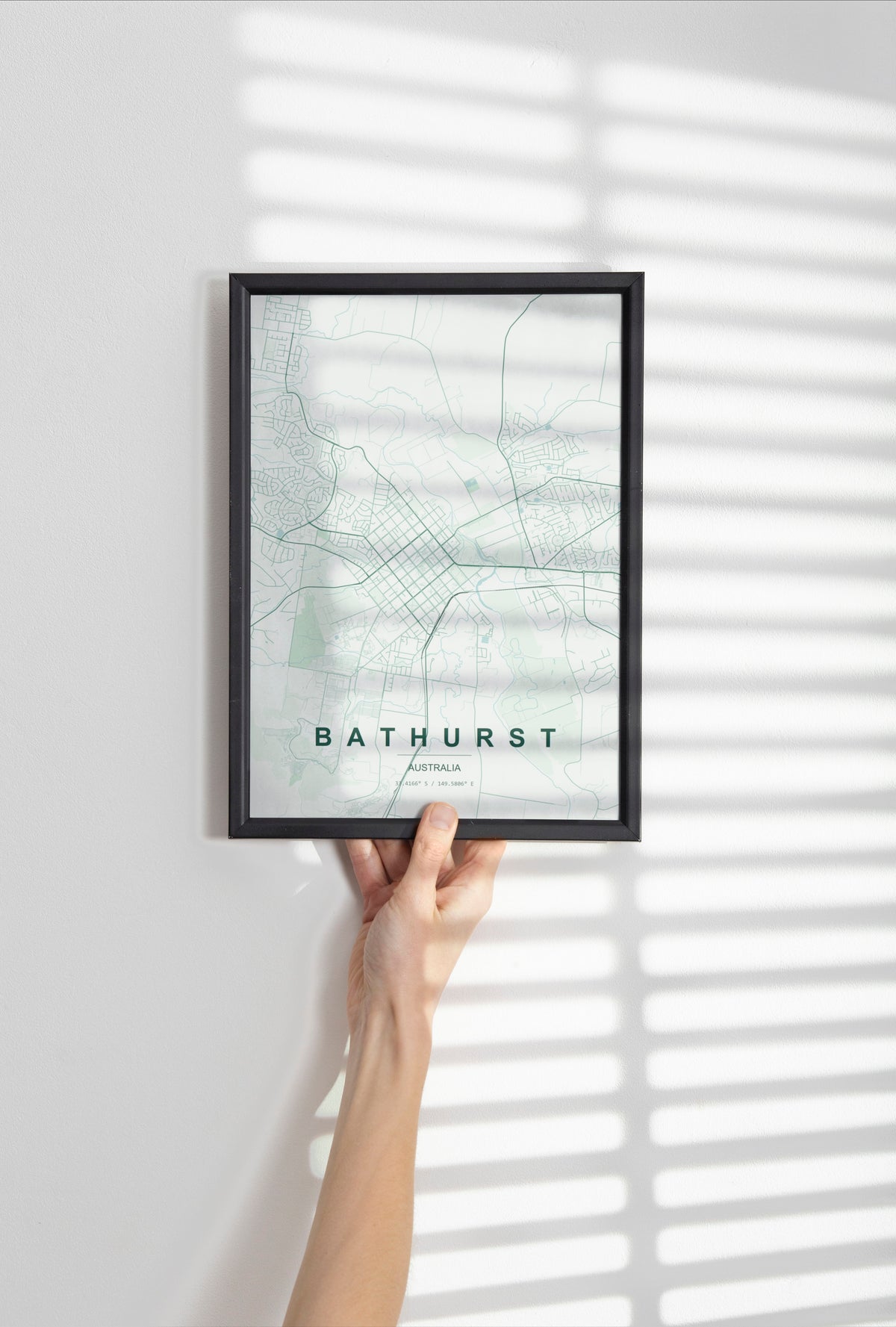 Bathurst, New South Wales, Australia map print in the Forest theme in a black frame held against a pale wall