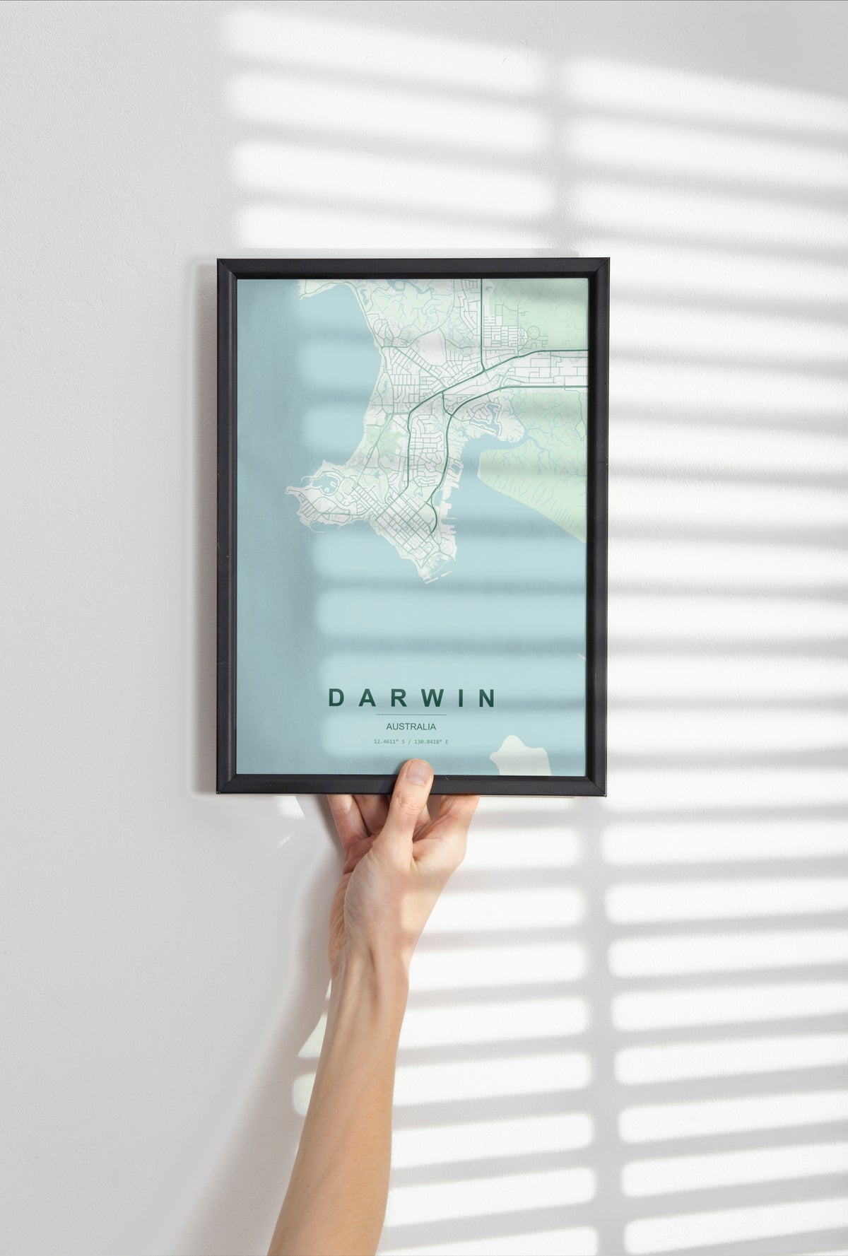 Darwin, Northern Territory, Australia map print in the Forest theme in a black frame held against a pale wall