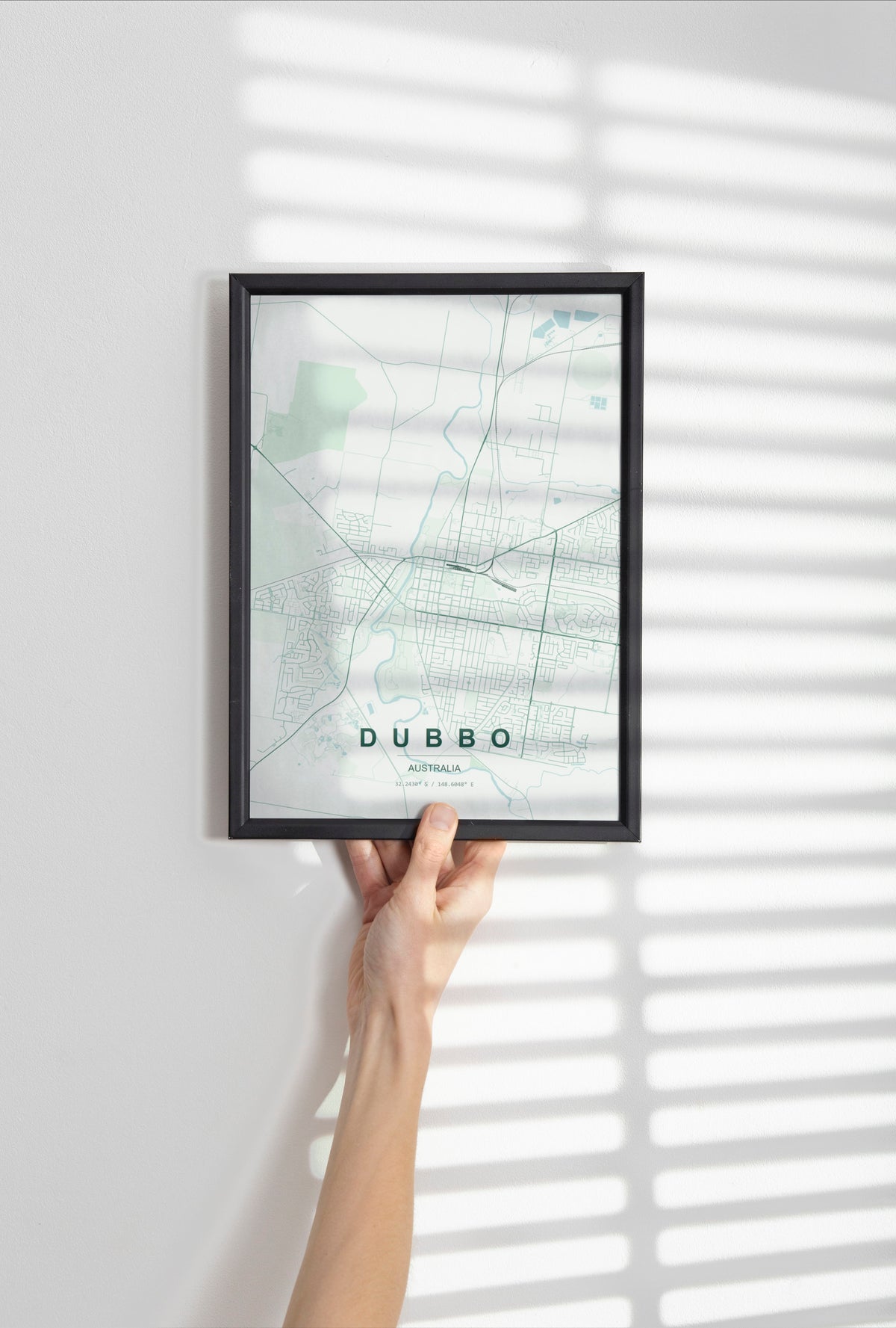 Dubbo, New South Wales, Australia map print in the Forest theme in a black frame held against a pale wall
