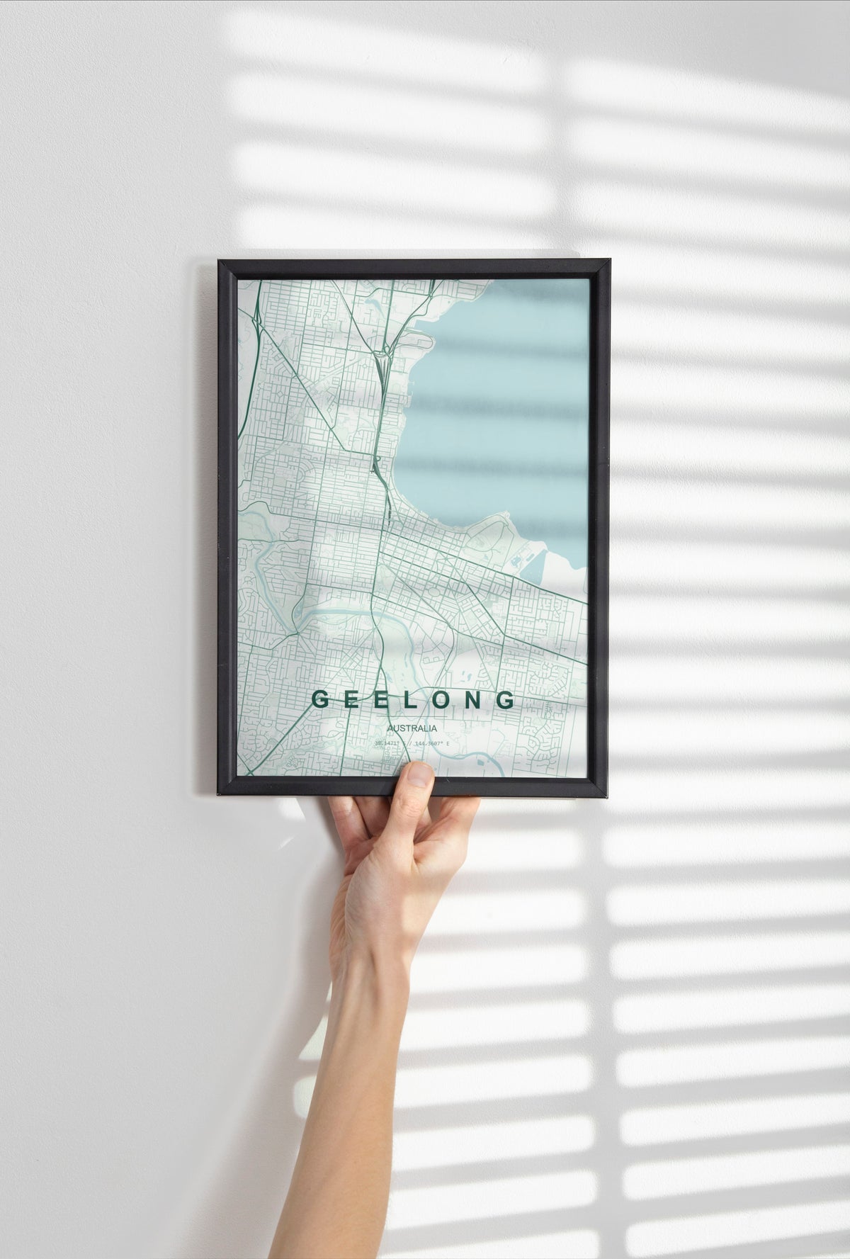 Geelong, Victoria, Australia map print in the Forest theme in a black frame held against a pale wall