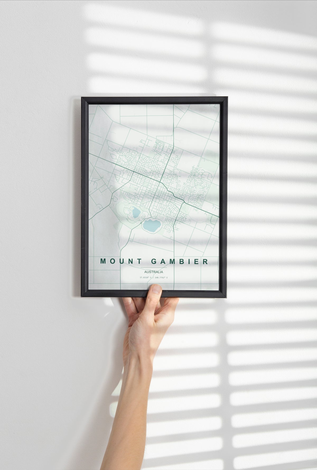 Mount Gambier, South Australia, Australia map print in the Forest theme in a black frame held against a pale wall