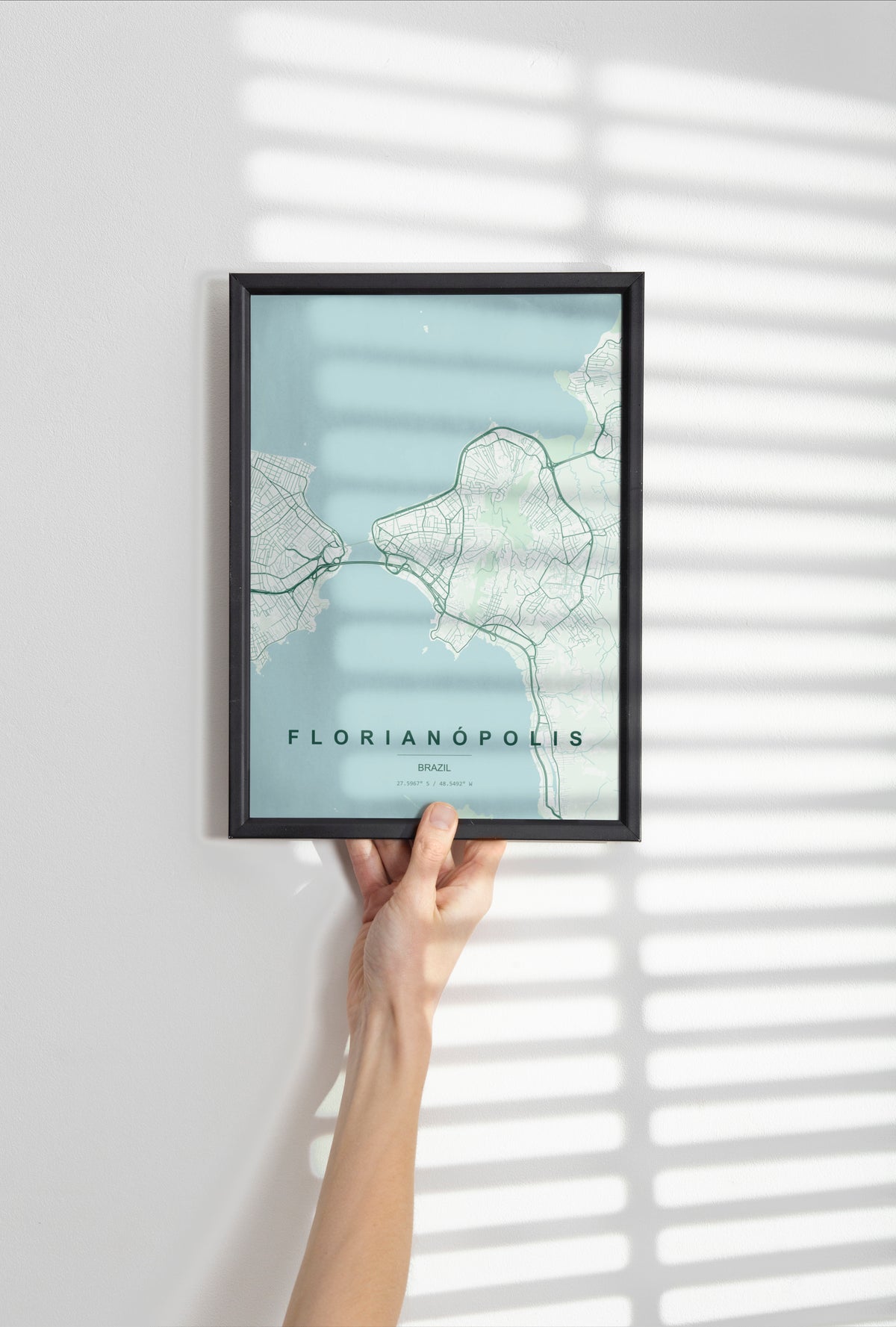 Florianópolis, Brazil map print in the Forest theme in a black frame held against a pale wall