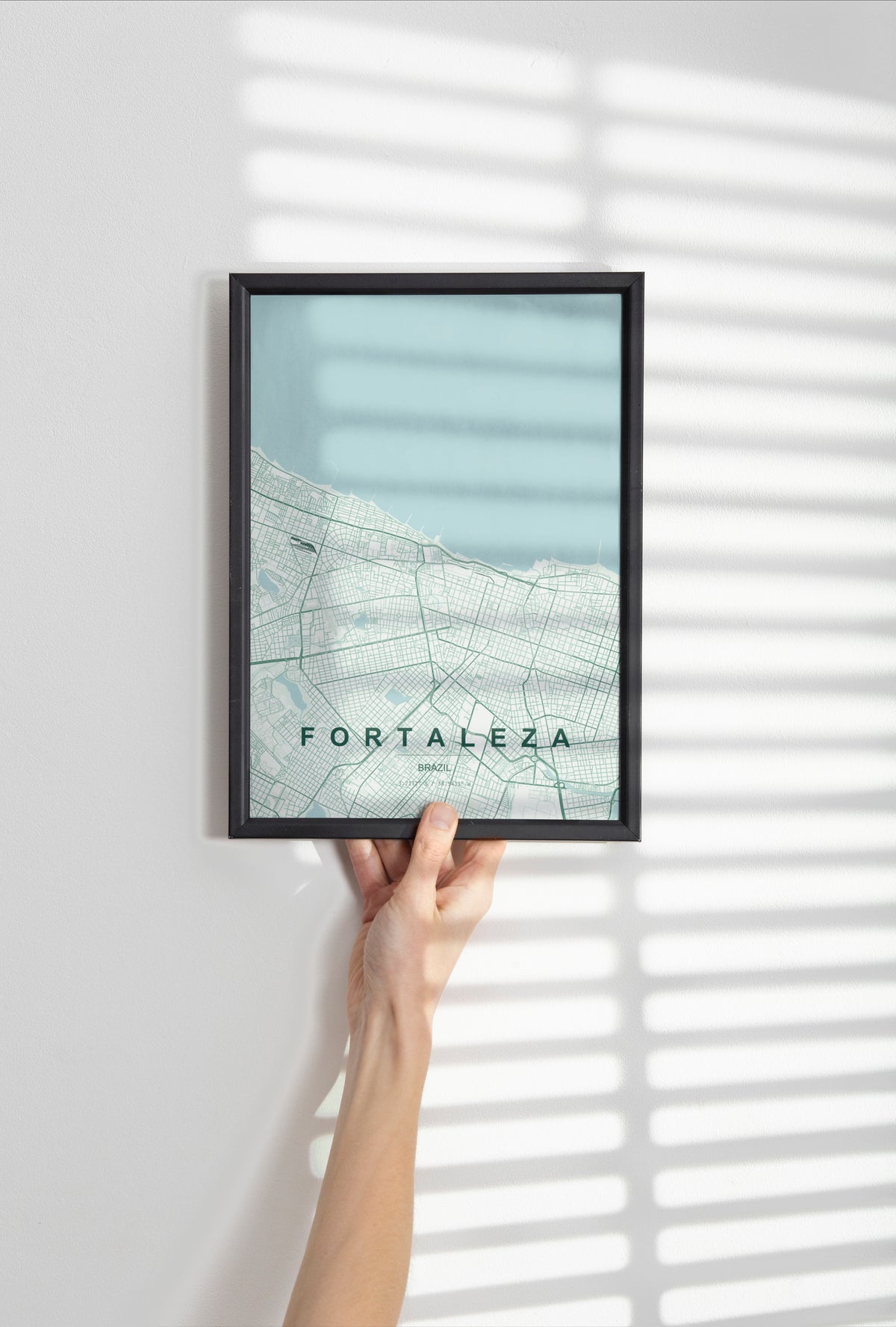 Fortaleza, Brazil map print in the Forest theme in a black frame held against a pale wall