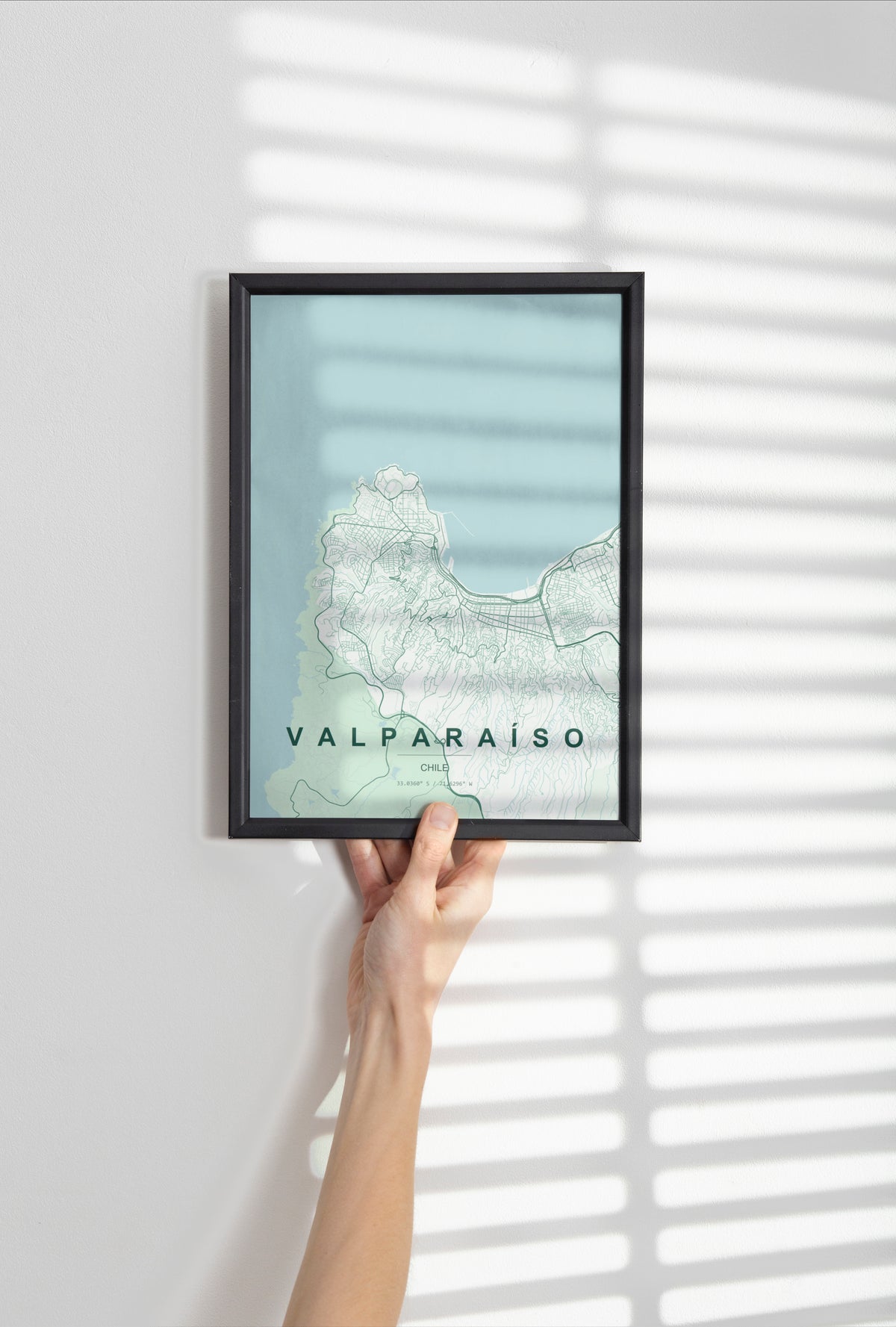 Valparaíso, Chile map print in the Forest theme in a black frame held against a pale wall