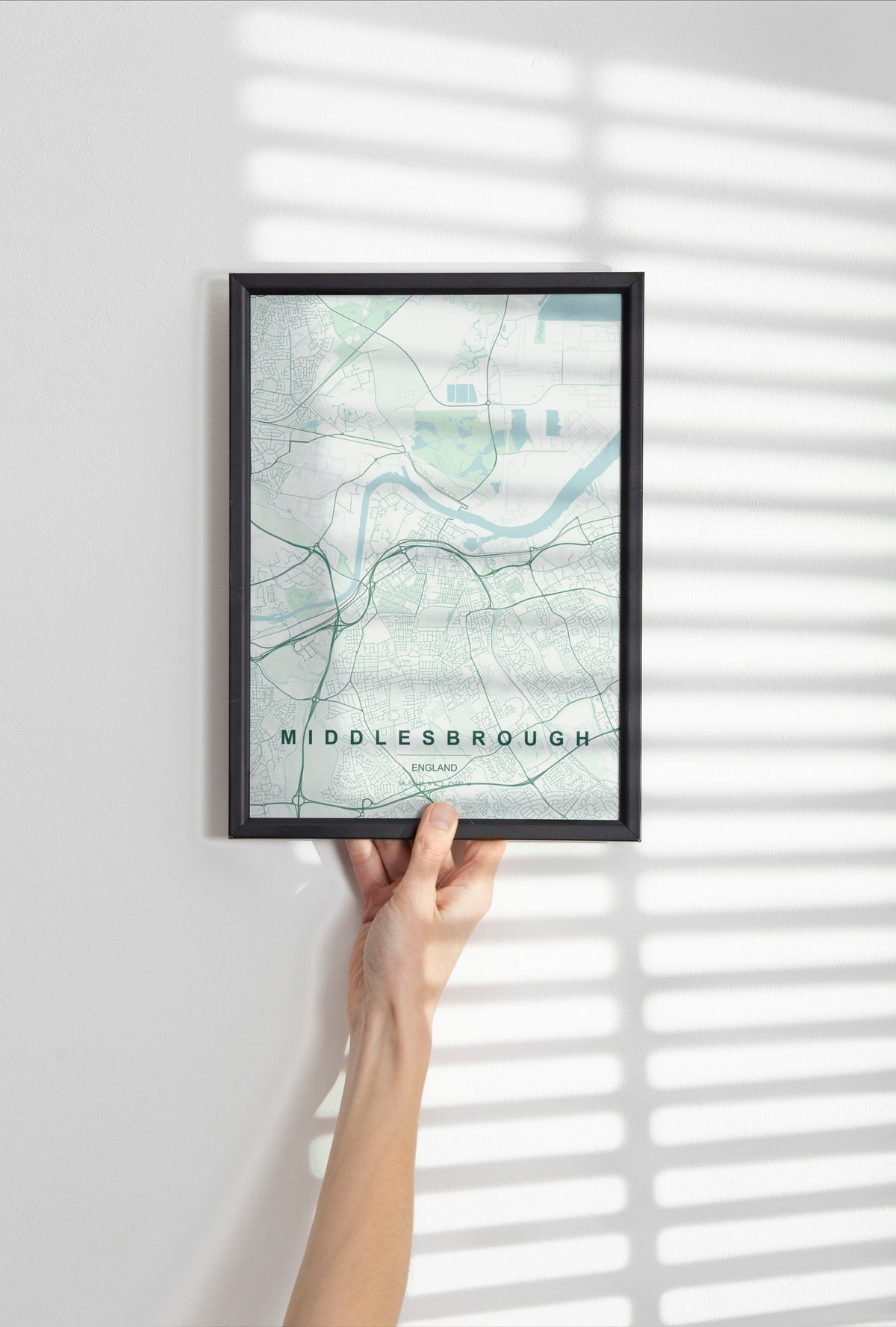 Middlesbrough, England, United Kingdom map print in the Forest theme in a black frame held against a pale wall