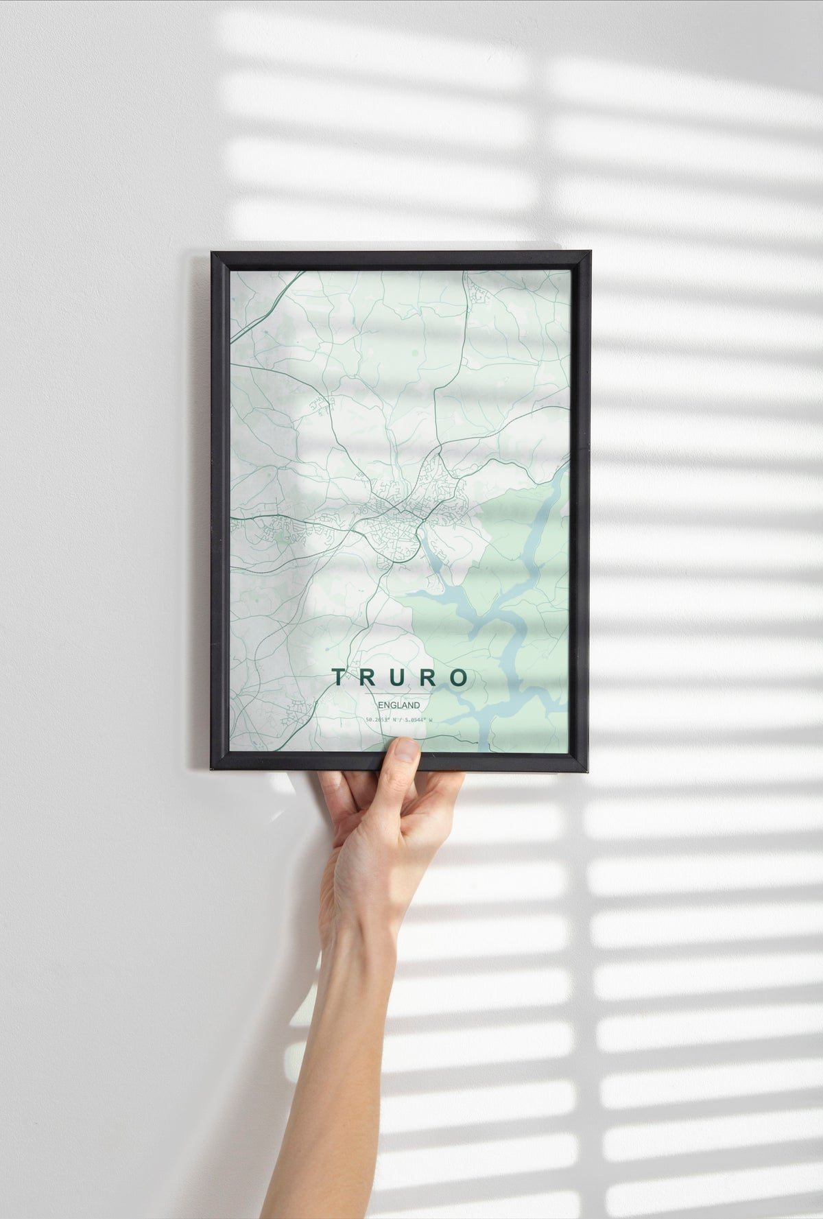 Truro, England, United Kingdom map print in the Forest theme in a black frame held against a pale wall