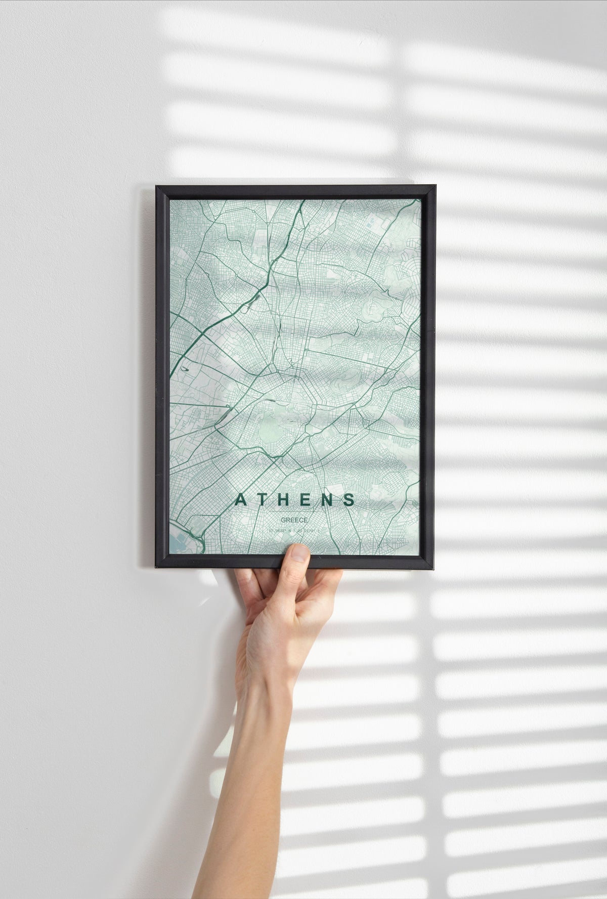 Athens map print in the Forest theme in a black frame held against a pale wall