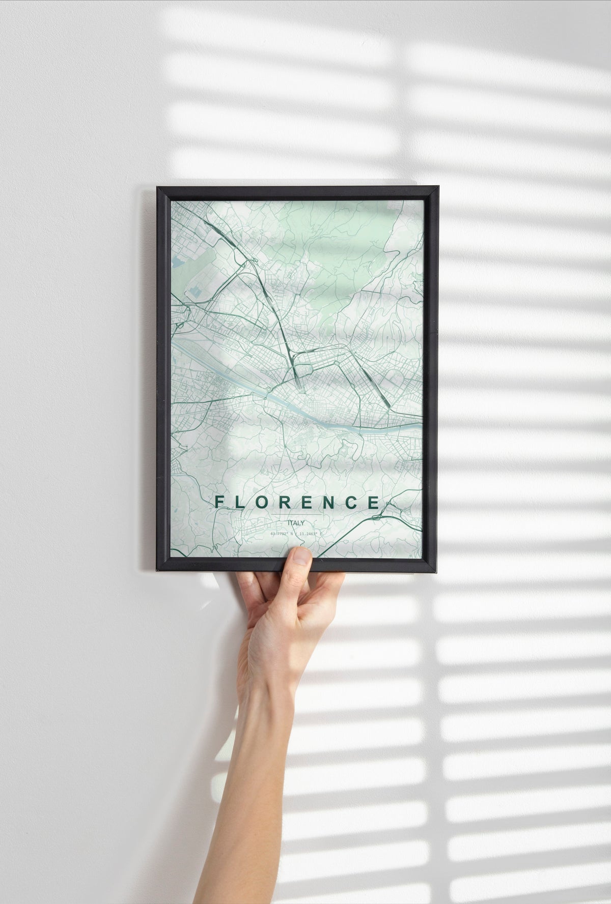 Florence map print in the Forest theme in a black frame held against a pale wall