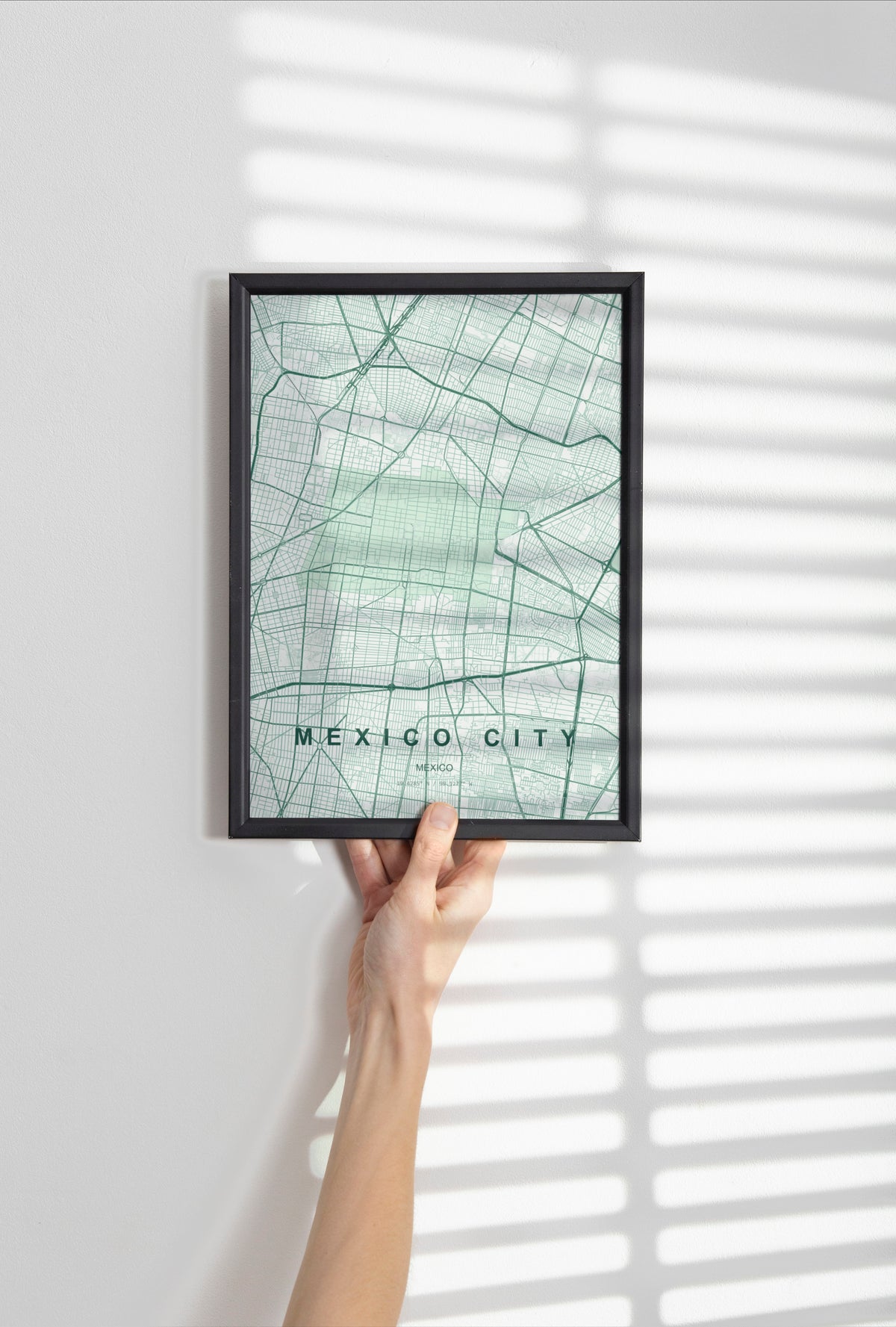 Mexico City, Mexico map print in the Forest theme in a black frame held against a pale wall