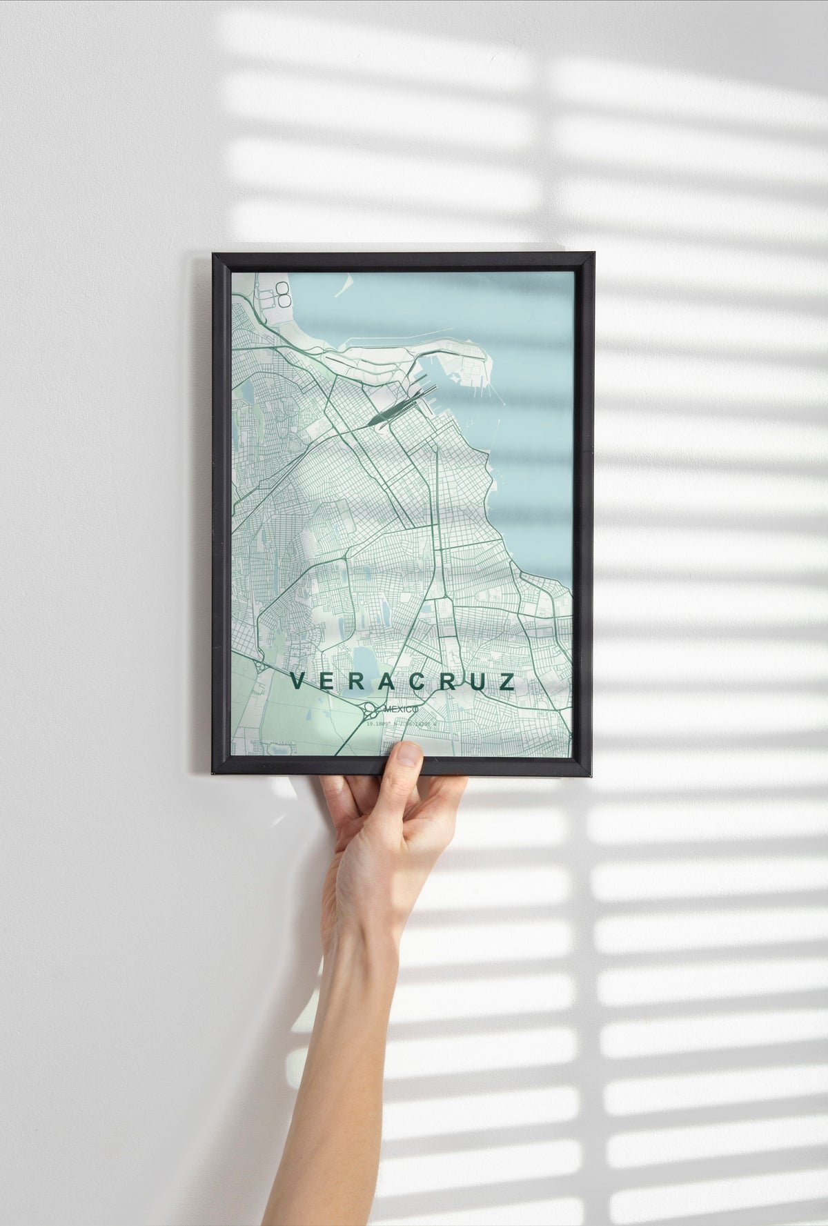 Veracruz, Mexico map print in the Forest theme in a black frame held against a pale wall
