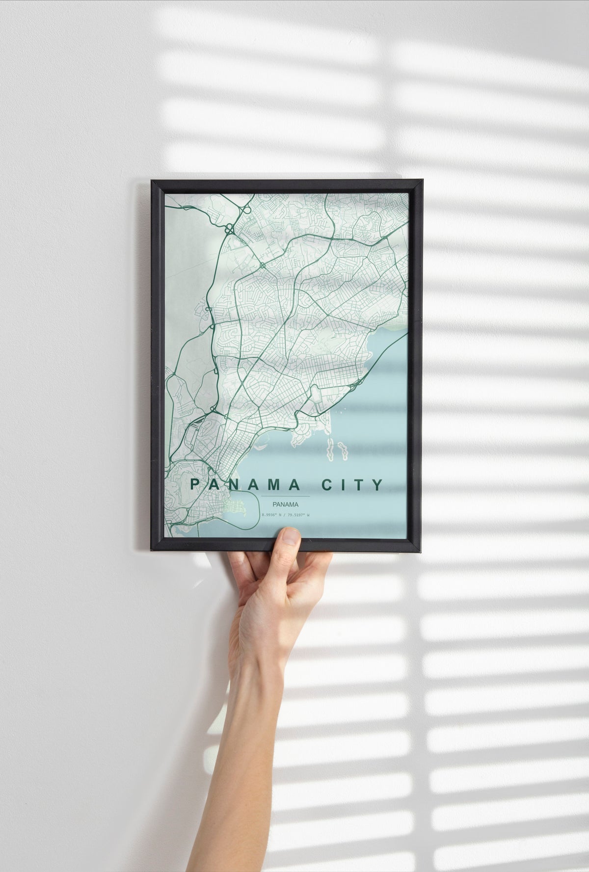 Panama City, Panama map print in the Forest theme in a black frame held against a pale wall