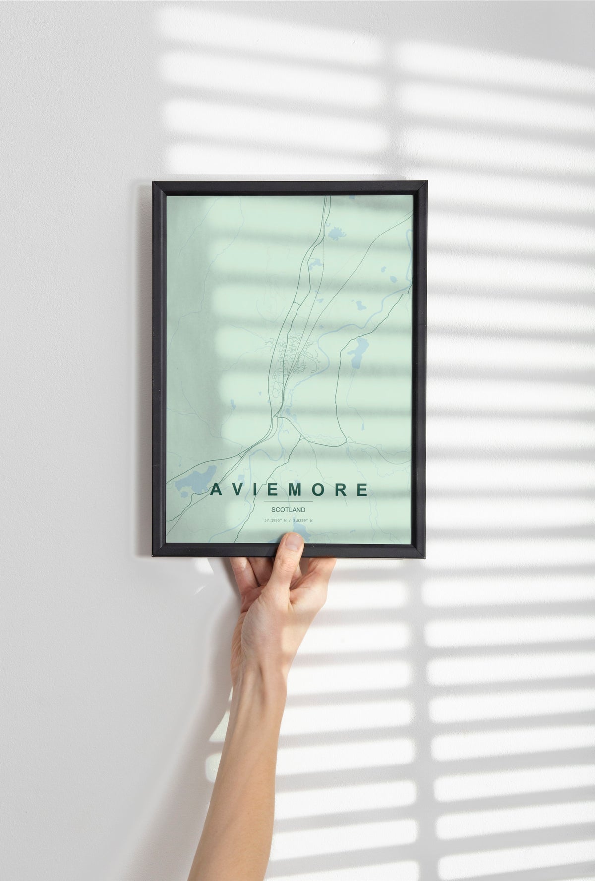 Aviemore, Scotland, United Kingdom map print in the Forest theme in a black frame held against a pale wall