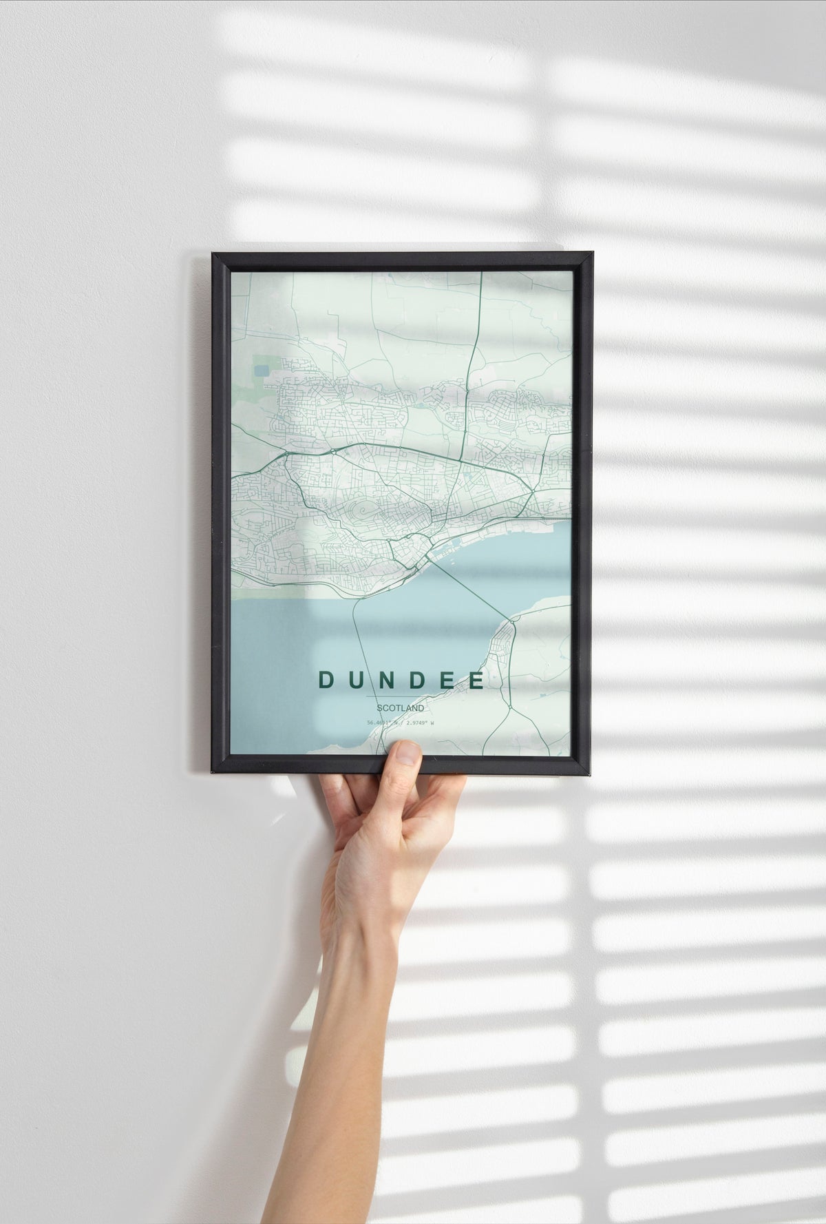 Dundee, Scotland, United Kingdom map print in the Forest theme in a black frame held against a pale wall