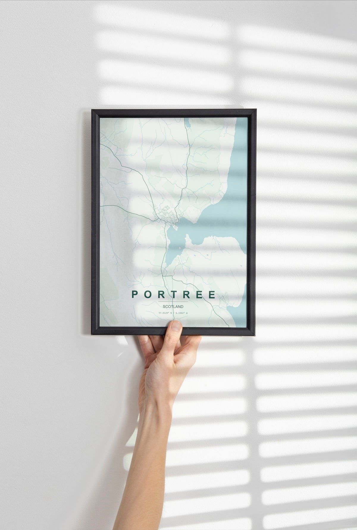 Portree, Scotland, United Kingdom map print in the Forest theme in a black frame held against a pale wall