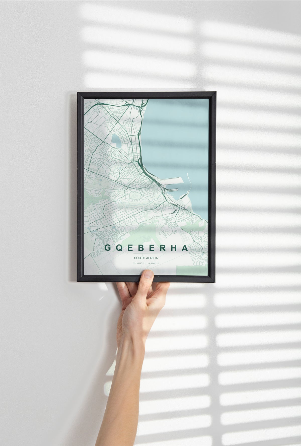 Gqeberha, Eastern Cape, South Africa map print in the Forest theme in a black frame held against a pale wall