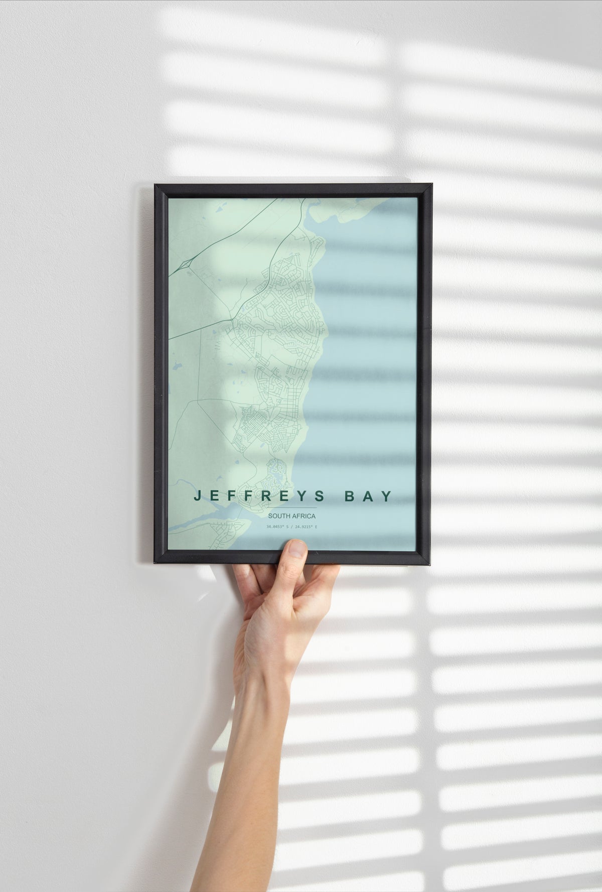 Jeffreys Bay, Eastern Cape, South Africa map print in the Forest theme in a black frame held against a pale wall