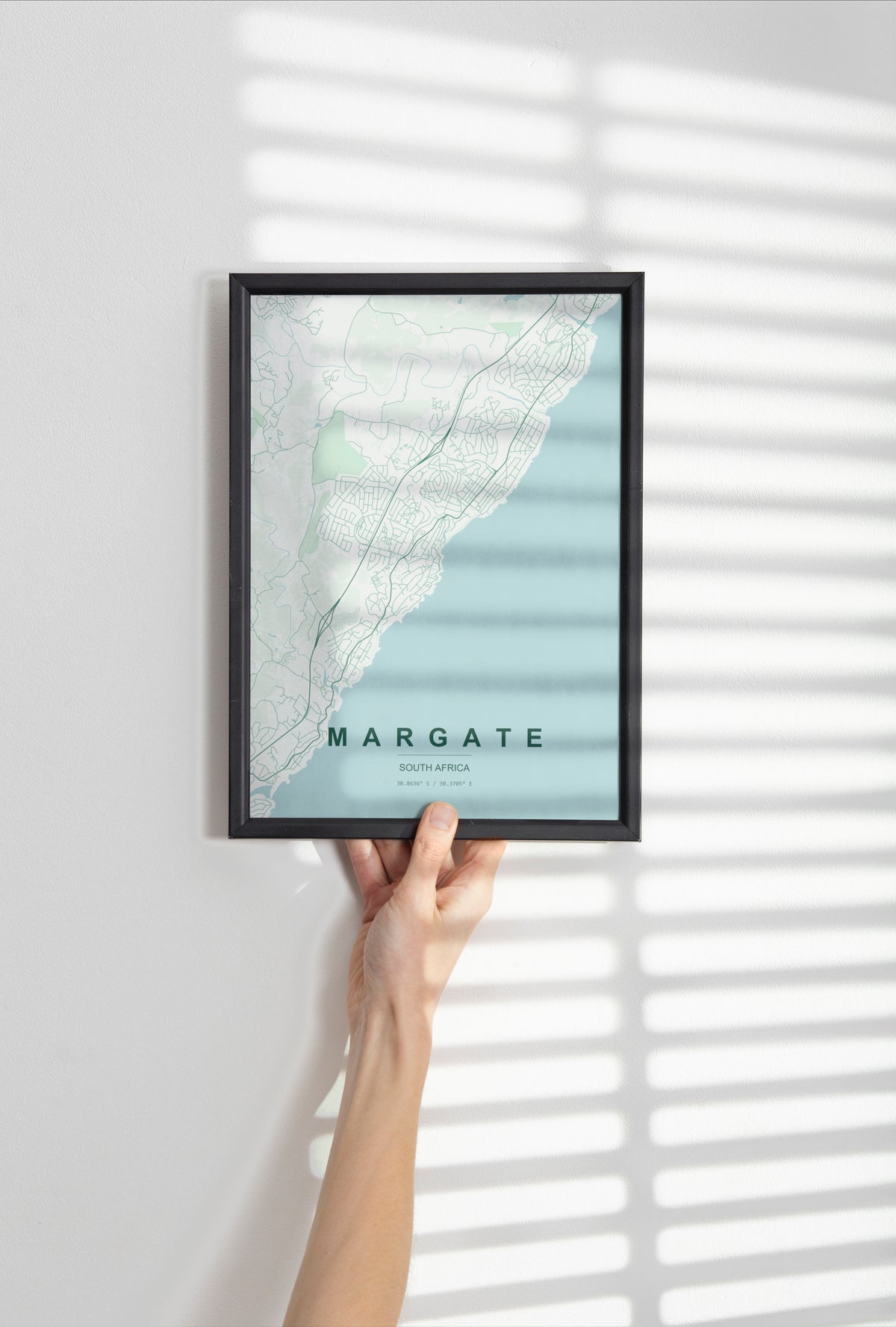 Margate, KwaZulu-Natal, South Africa map print in the Forest theme in a black frame held against a pale wall
