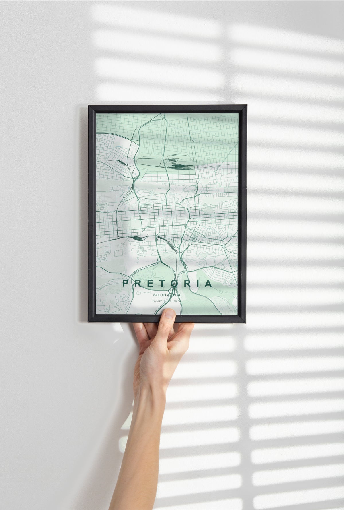 Pretoria, Gauteng, South Africa map print in the Forest theme in a black frame held against a pale wall