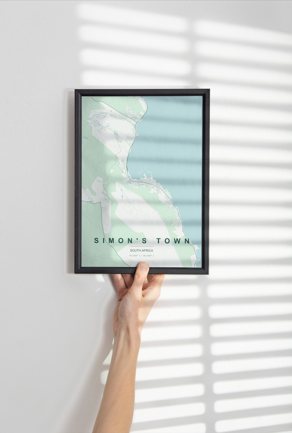 Simon's Town, Western Cape, South Africa map print in the Forest theme in a black frame held against a pale wall