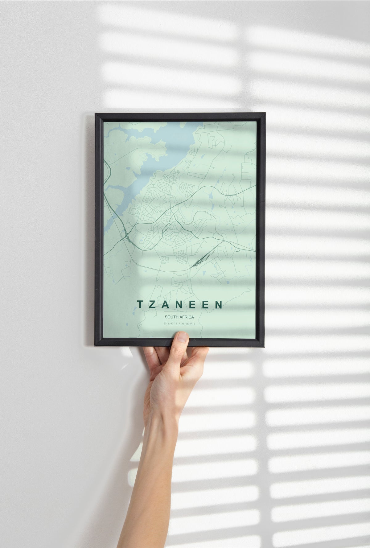 Tzaneen, Limpopo, South Africa map print in the Forest theme in a black frame held against a pale wall