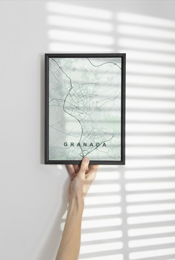 Granada map print in the Forest theme in a black frame held against a pale wall