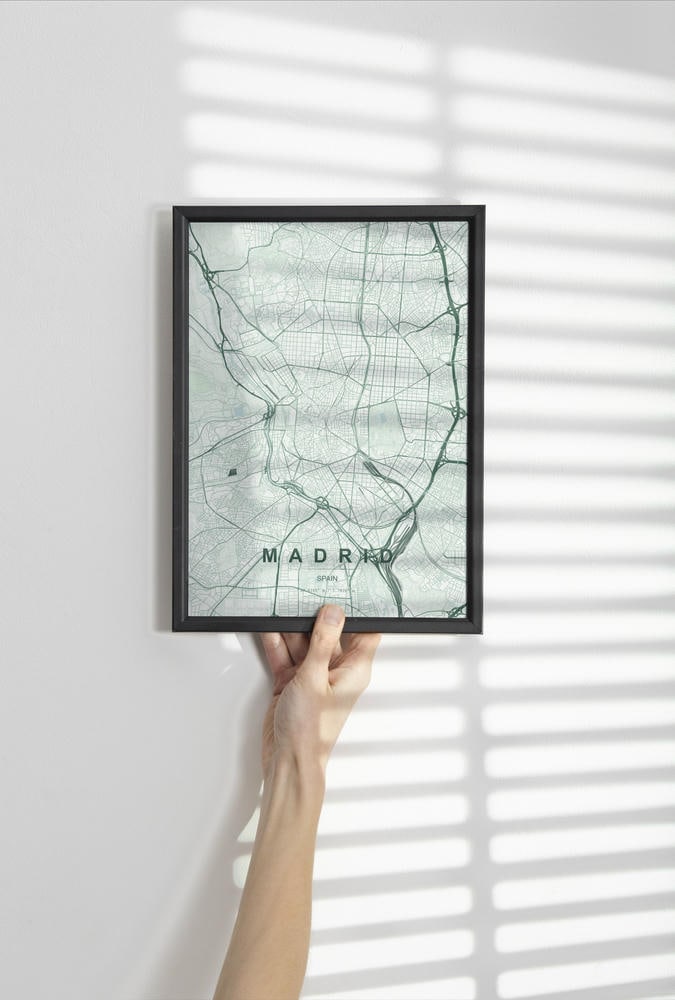 Madrid map print in the Forest theme in a black frame held against a pale wall