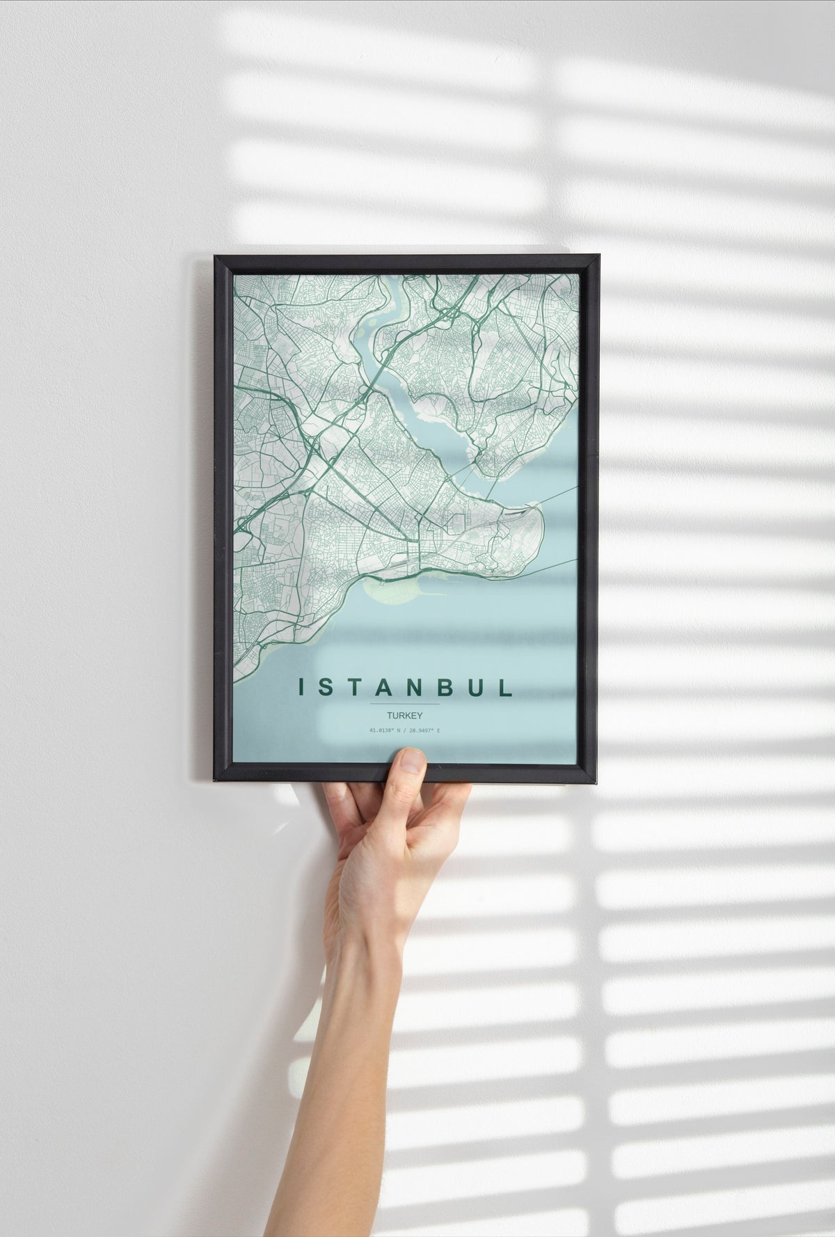 Istanbul, Turkey map print in the Forest theme in a black frame held against a pale wall