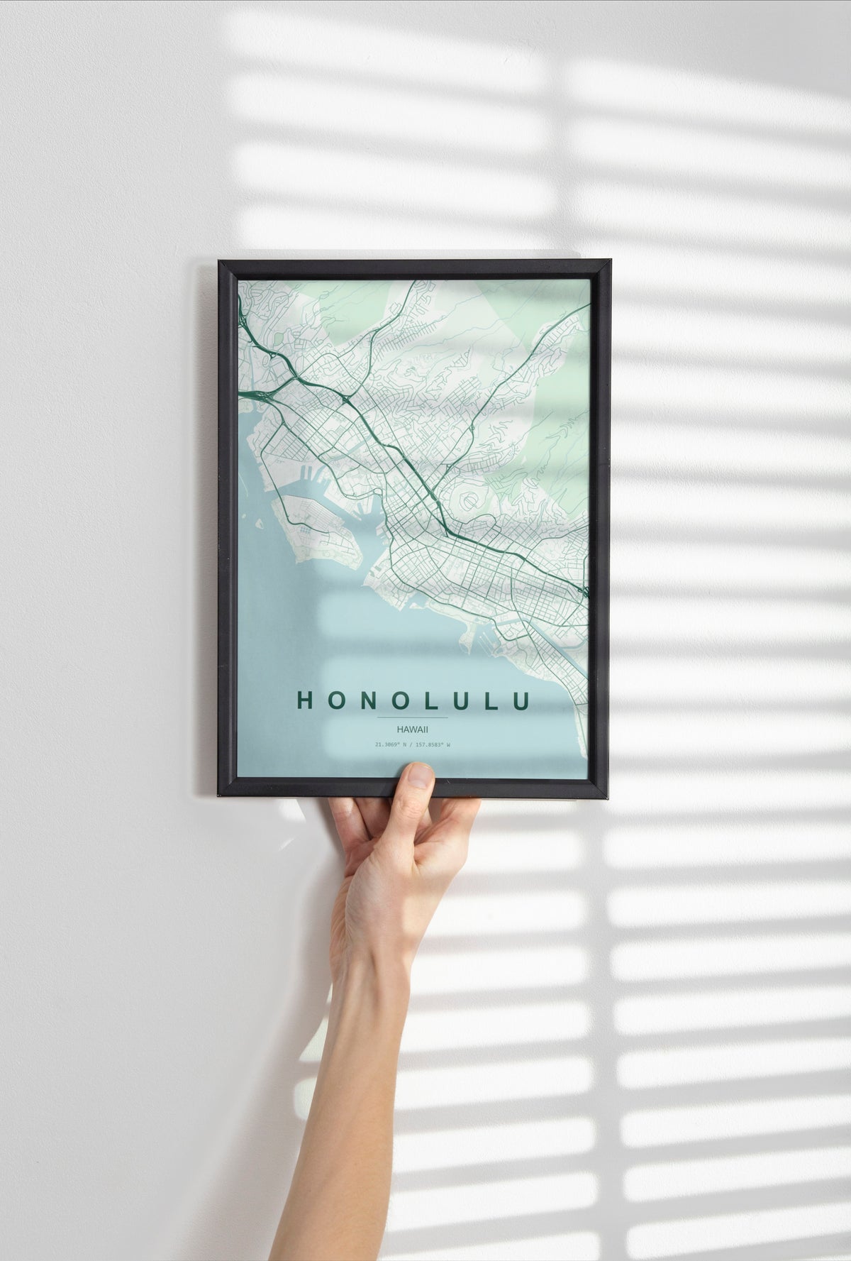 Honolulu, Hawaii, United States map print in the Forest theme in a black frame held against a pale wall