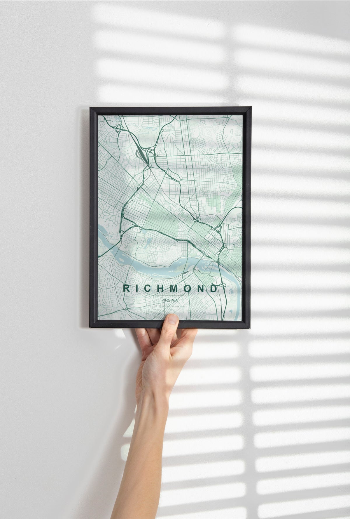 Richmond map print in the Forest theme in a black frame held against a pale wall