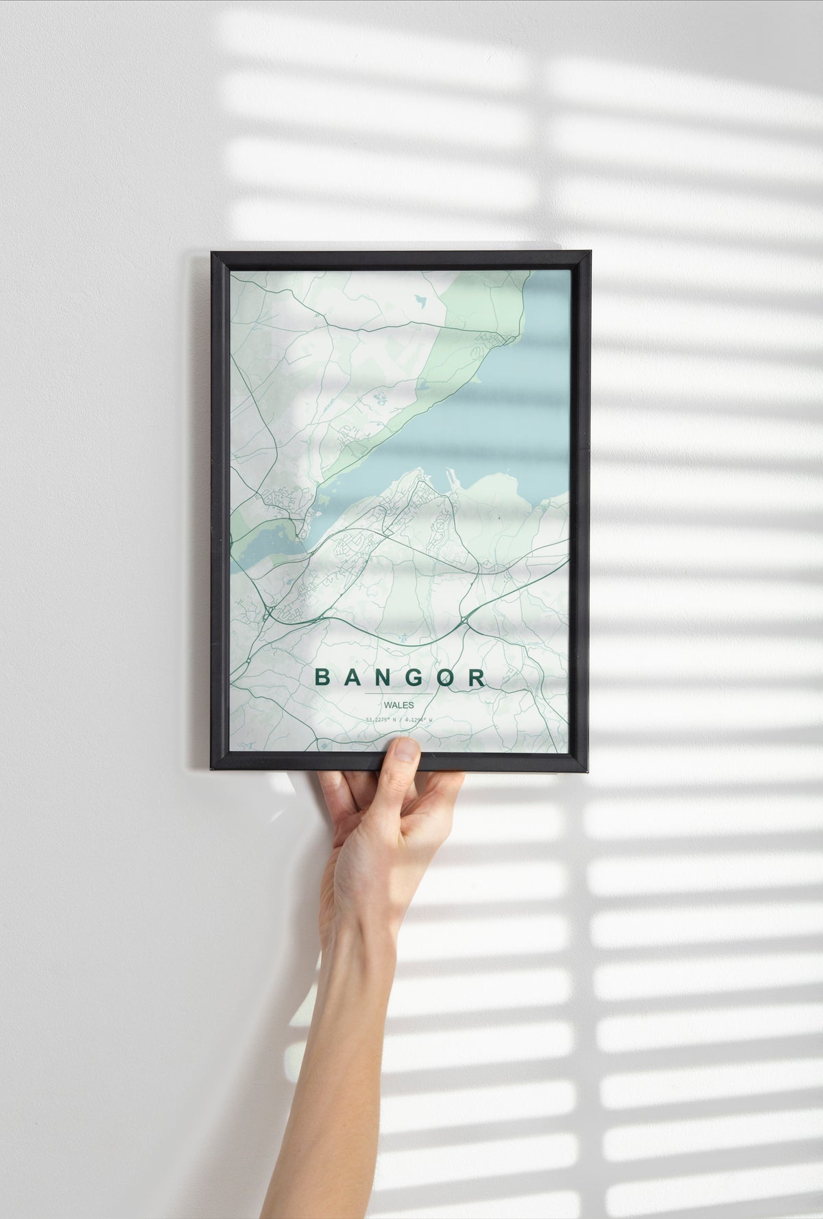 Bangor, Wales, United Kingdom map print in the Forest theme in a black frame held against a pale wall