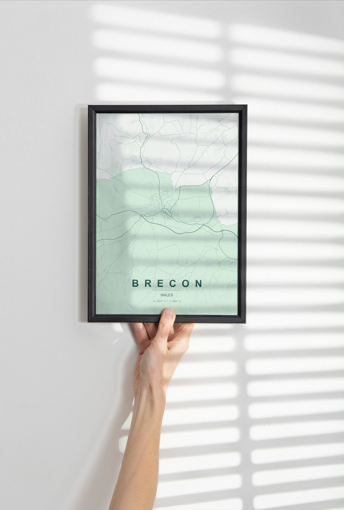 Brecon, Wales, United Kingdom map print in the Forest theme in a black frame held against a pale wall