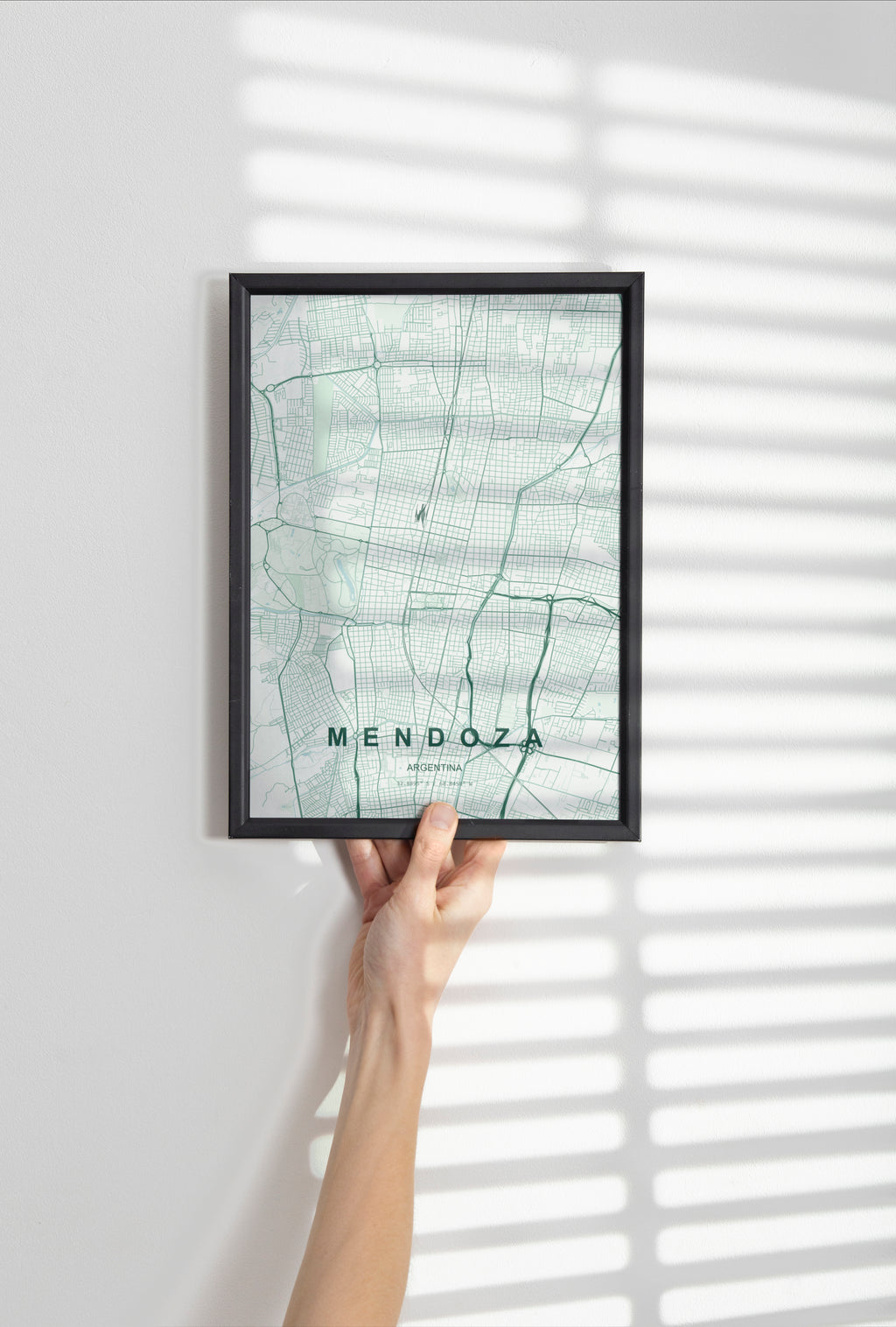 Mendoza, Argentina map print in the Forest theme in a black frame held against a pale wall