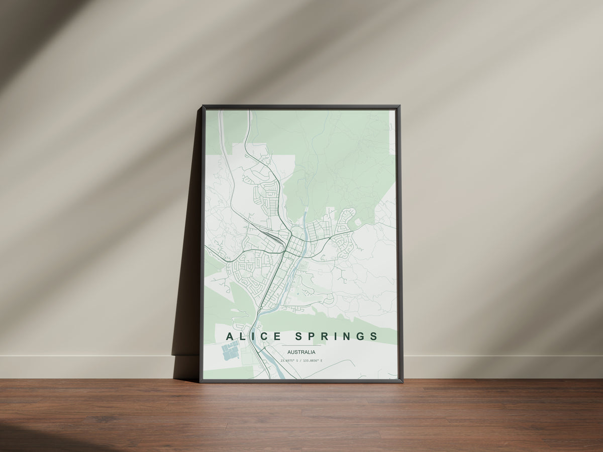 Alice Springs, Northern Territory, Australia map print in the Forest theme in a black frame on a wooden surface against a pale wall