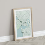 Perth, Western Australia, Australia map print in the Forest theme in a light wooden frame leaning against a pale wall
