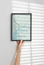 Perth, Western Australia, Australia map print in the Forest theme in a black frame held against a pale wall