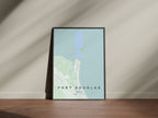 Port Douglas, Queensland, Australia map print in the Forest theme in a black frame on a wooden surface against a pale wall