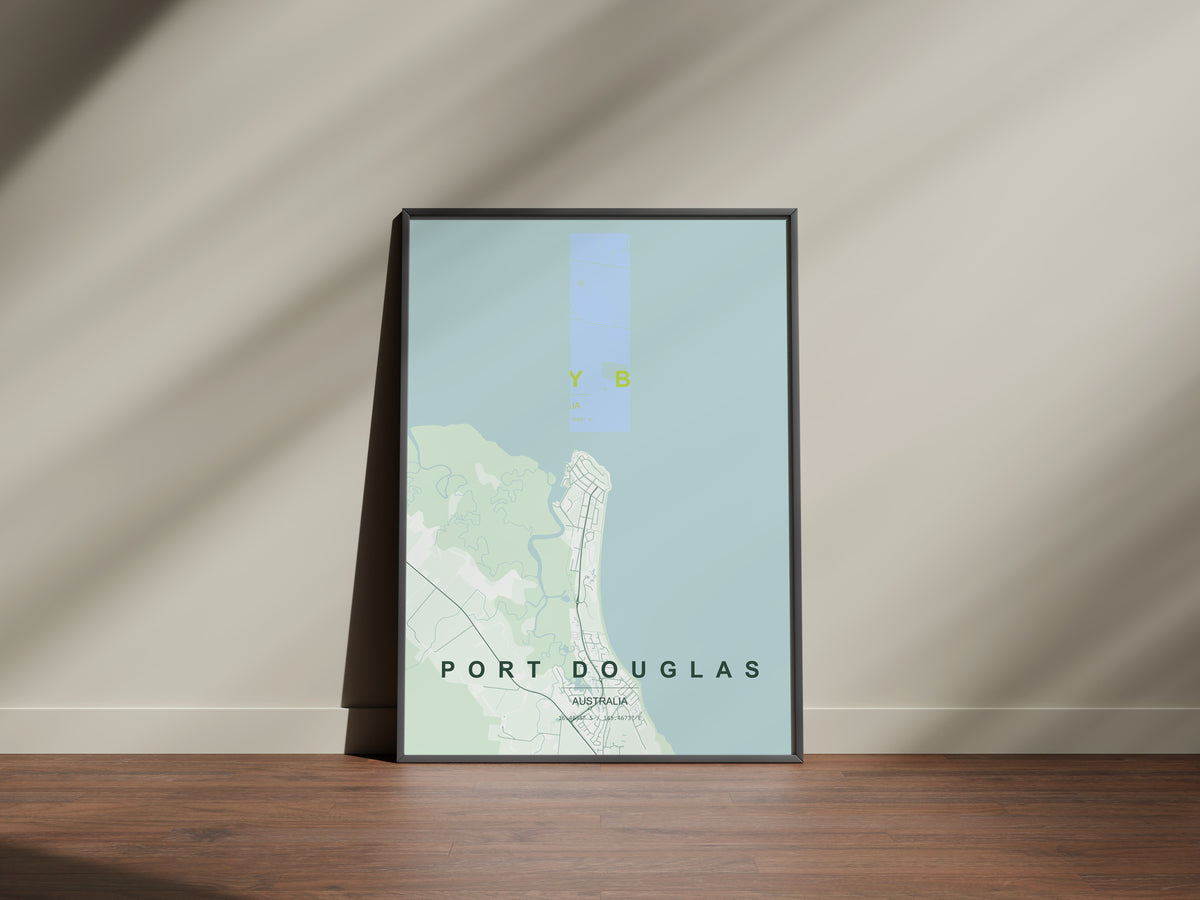 Port Douglas, Queensland, Australia map print in the Forest theme in a black frame on a wooden surface against a pale wall