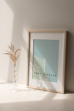 Port Douglas, Queensland, Australia map print in the Forest theme in a light wooden frame on a shelf beside a glass vase