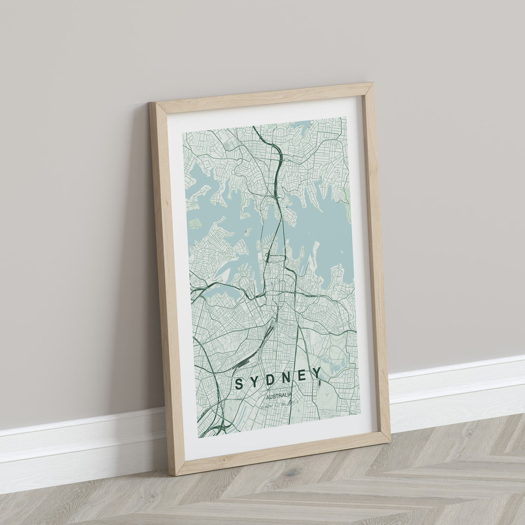 Sydney, New South Wales, Australia map print in the Forest theme in a light wooden frame leaning against a pale wall