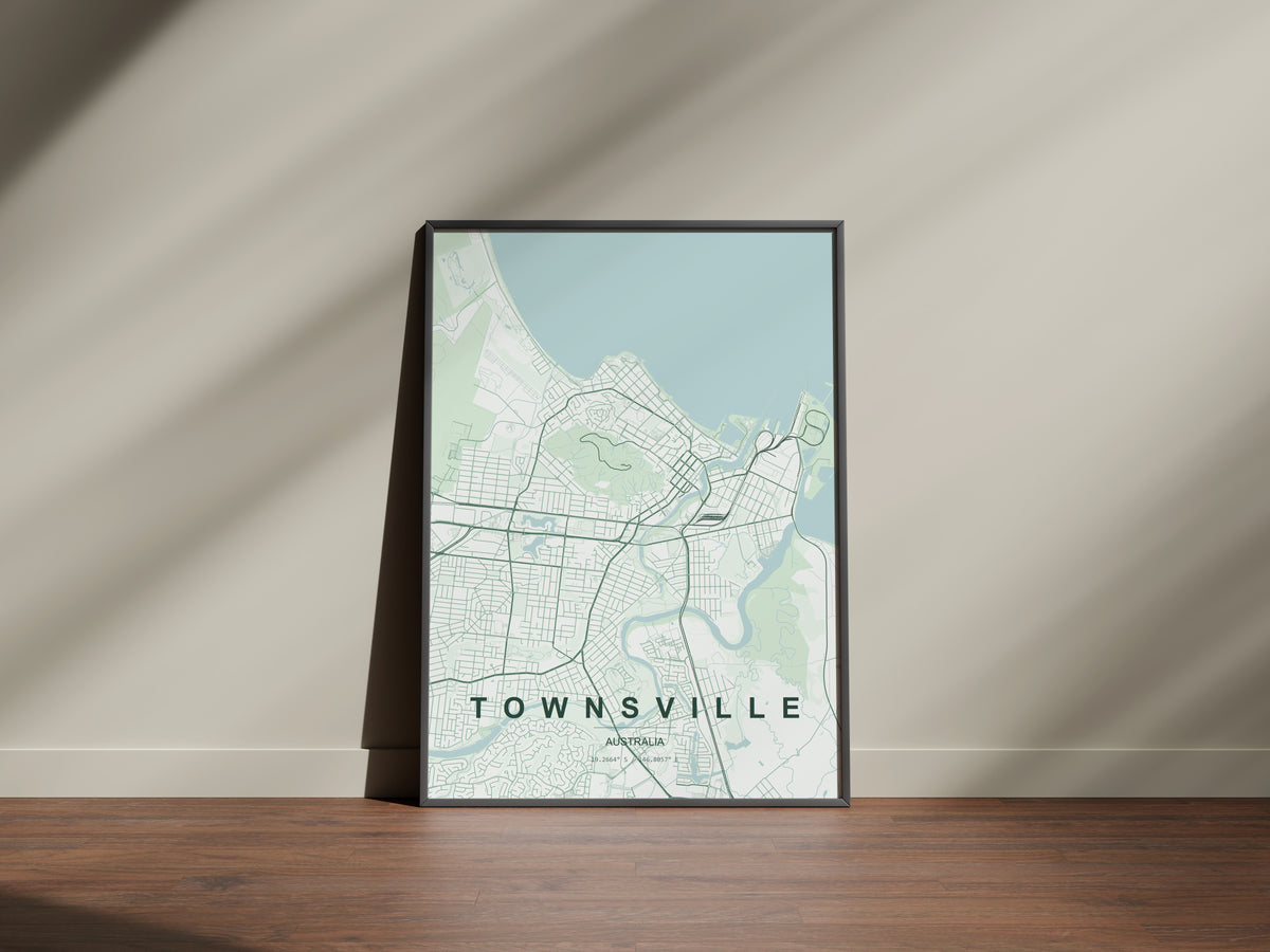 Townsville, Queensland, Australia map print in the Forest theme in a black frame on a wooden surface against a pale wall