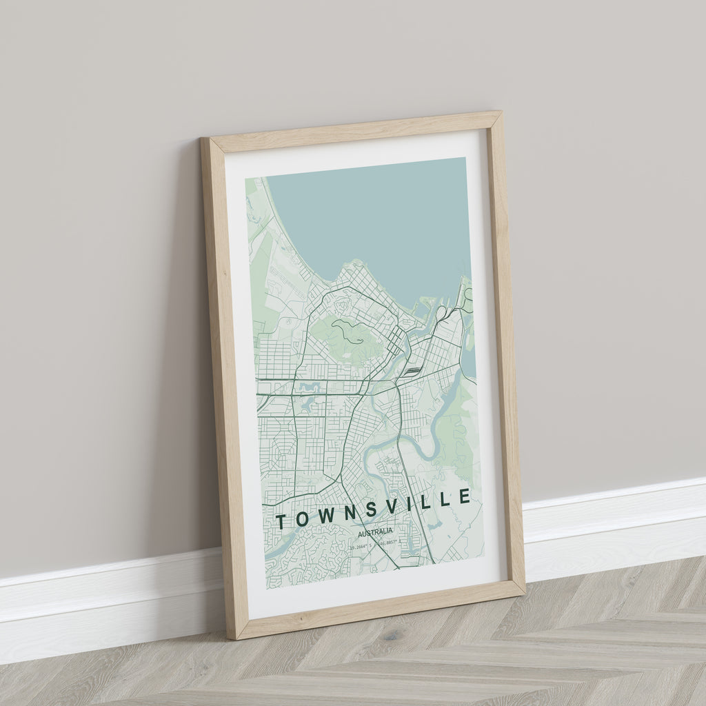 Townsville, Queensland, Australia map print in the Forest theme in a light wooden frame leaning against a pale wall