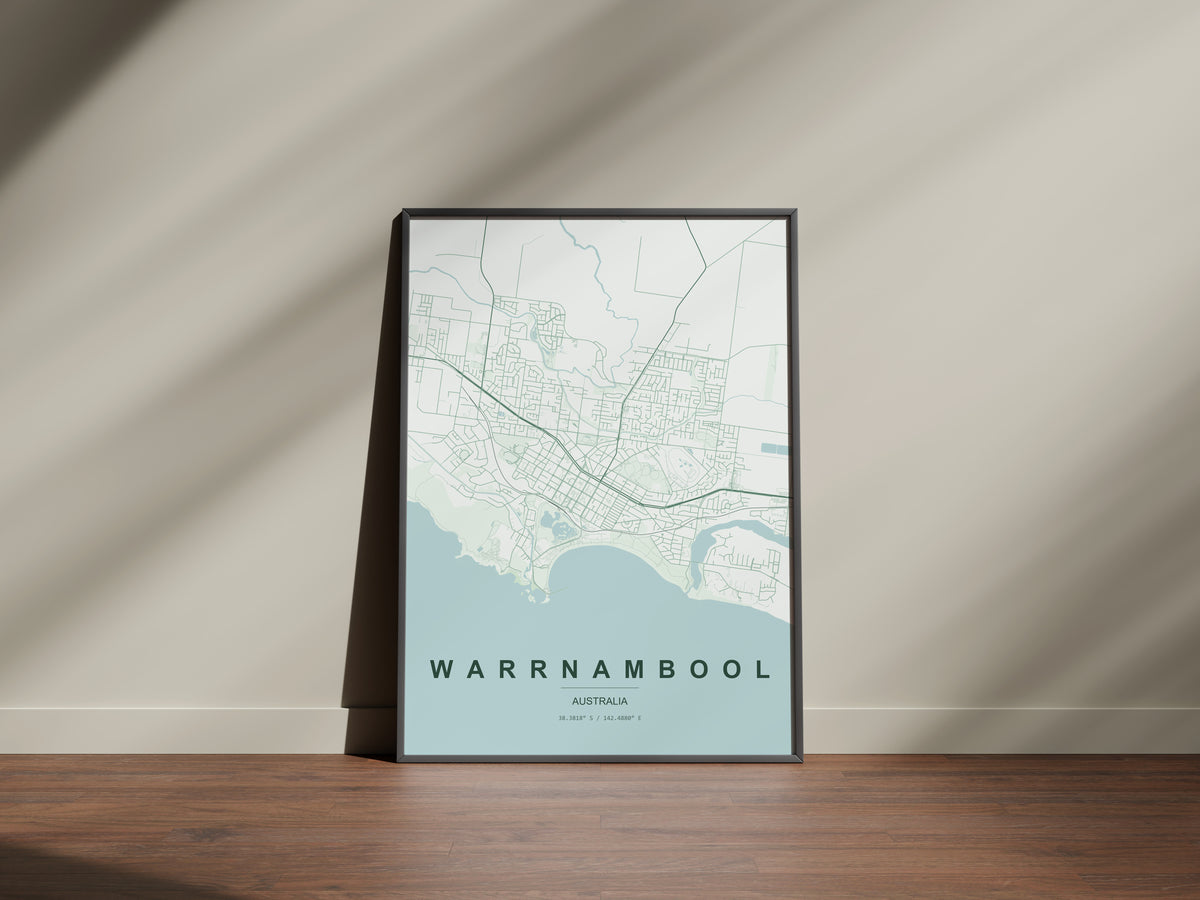 Warrnambool, Victoria, Australia map print in the Forest theme in a black frame on a wooden surface against a pale wall
