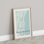 Wollongong, New South Wales, Australia map print in the Forest theme in a light wooden frame leaning against a pale wall