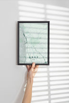 Graz map print in the Forest theme in a black frame held against a pale wall