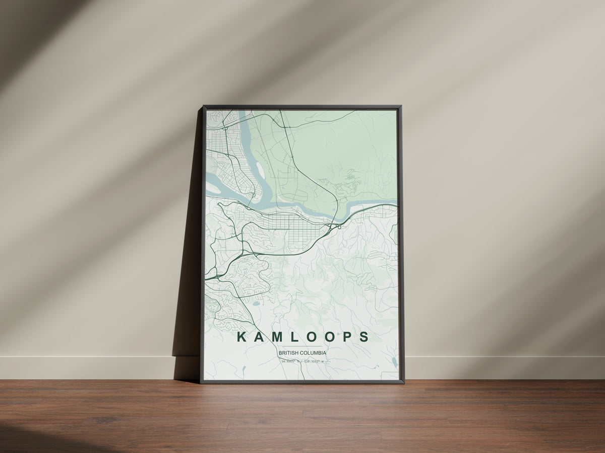 Kamloops, British Columbia, Canada map print in the Forest theme in a black frame on a wooden surface against a pale wall