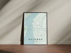 Kelowna, British Columbia, Canada map print in the Forest theme in a black frame on a wooden surface against a pale wall