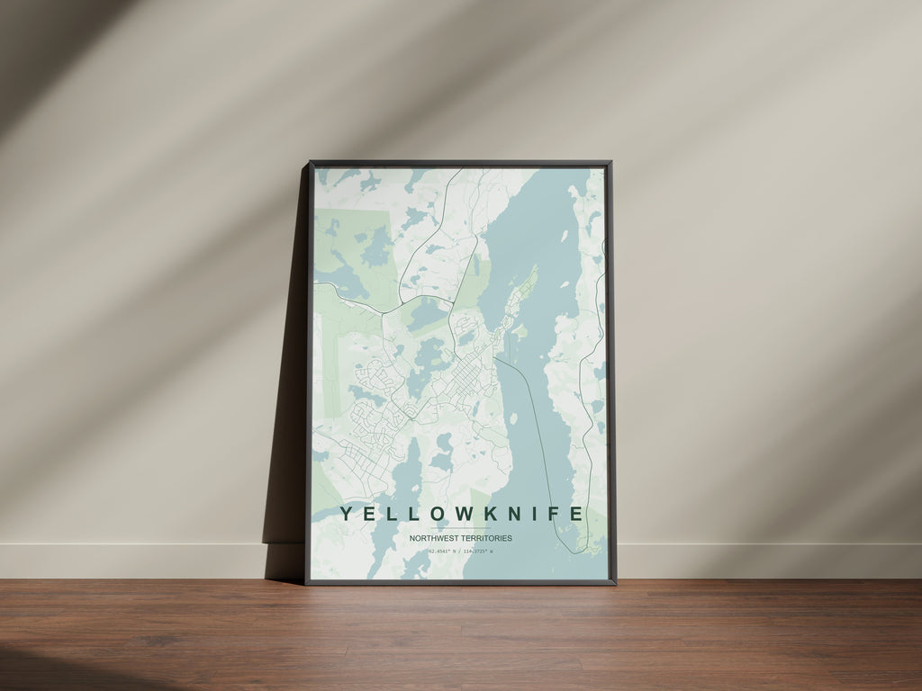Yellowknife, Northwest Territories, Canada map print in the Forest theme in a black frame on a wooden surface against a pale wall