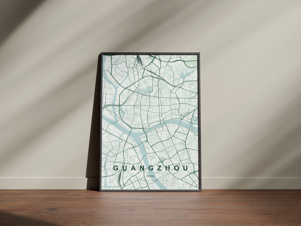 Guangzhou, China map print in the Forest theme in a black frame on a wooden surface against a pale wall