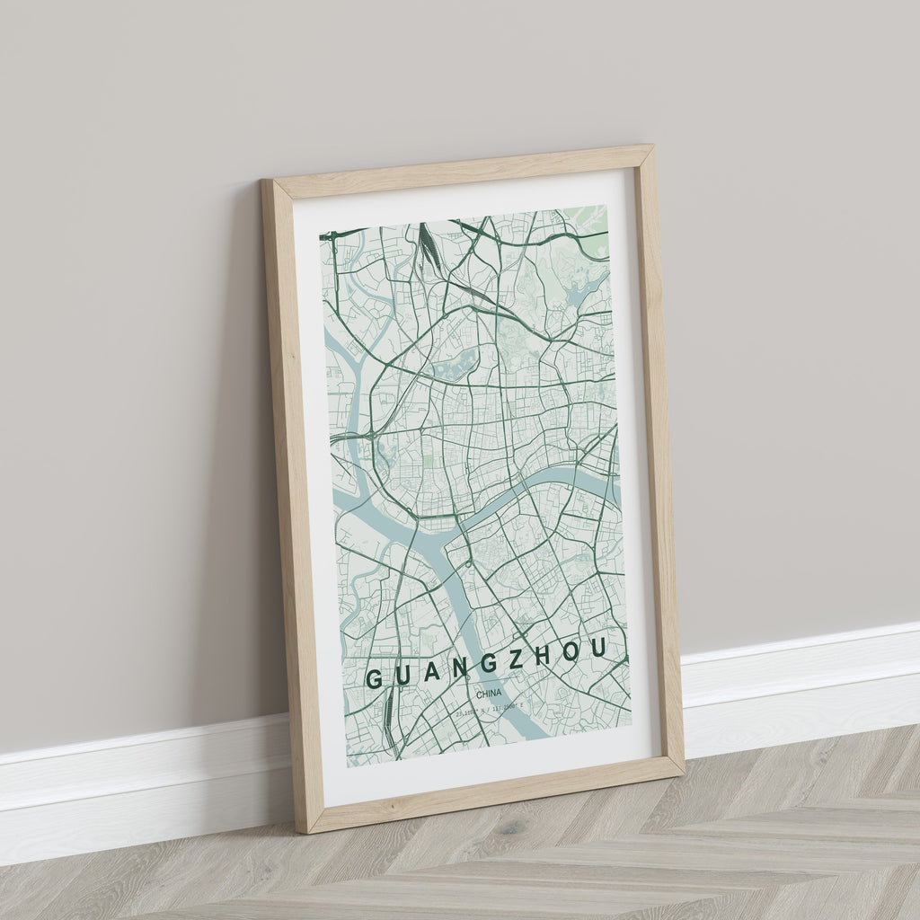 Guangzhou, China map print in the Forest theme in a light wooden frame leaning against a pale wall
