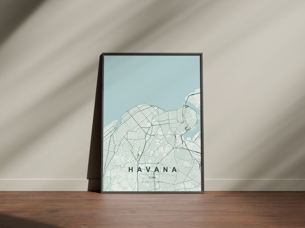 Havana, Cuba map print in the Forest theme in a black frame on a wooden surface against a pale wall
